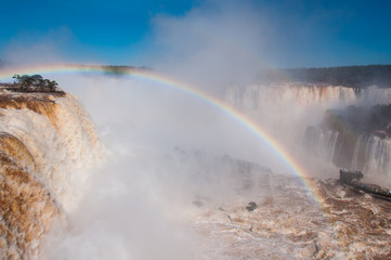 Rainbow over gorgeous waterfalls of Iguazu, Brazil