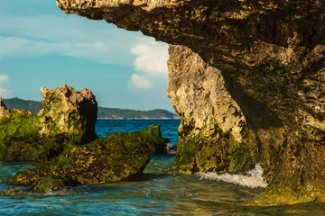 Tropical rock island with green stones on deep blue summer sea Philippines Boracay island