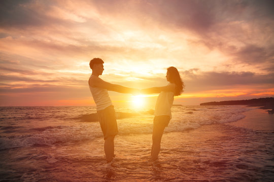 young couple  at sunset on beach