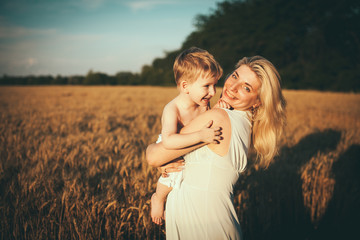 Portrait of happy loving mother and her baby outdoors