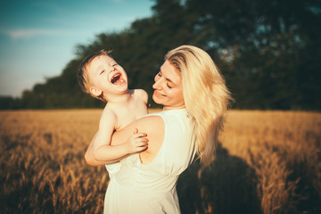 Portrait of happy loving mother and her baby outdoors 