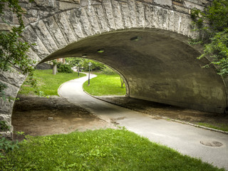 Path going under a stone bridge in Central Park
