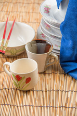  bowl and chopsticks on bamboo mat.