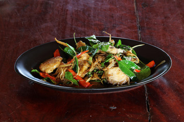 Stir-Fried Spicy Fish on the wooden table