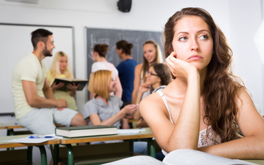 Lonely female student in college classroom