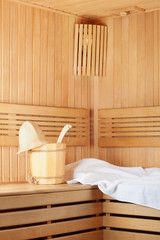 Fototapeta na wymiar Traditional wooden sauna for relaxation with bucket of water
