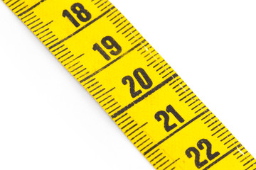 Yellow measuring tape isolated - selective focus