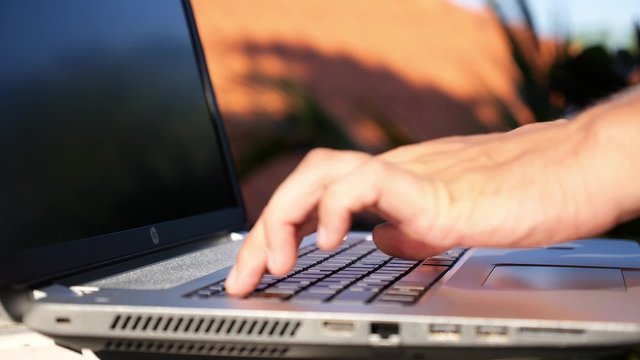 Closeup of Business Man Hand Typing on Laptop Keyboard