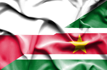 Obraz premium Waving flag of Suriname and Poland