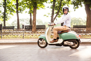 Trendy man driving a scooter in helmet © Drobot Dean