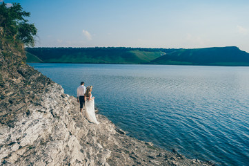 beautiful gorgeous blonde bride and stylish groom, on the backgr