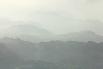 Mountain landscape in the mist on the horizon