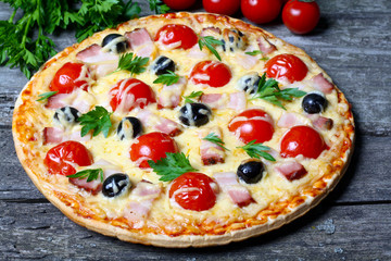 pizza with bacon, olives and tomato