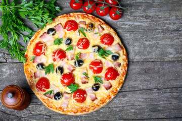 Fototapeta na wymiar pizza with bacon, olives and tomato
