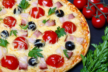 pizza with bacon, olives and tomato