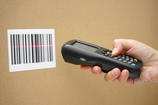Scanning label on the box with barcode scanner