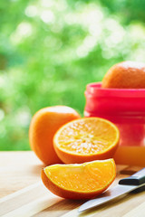 Oranges, juicer and knife