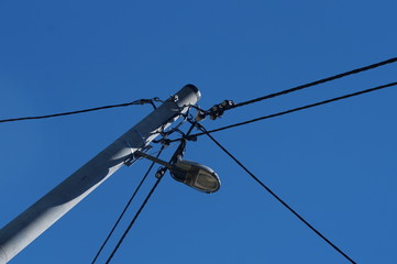 Słup oświetlenia z kablami telekomunikacyjnymi i elektrycznością