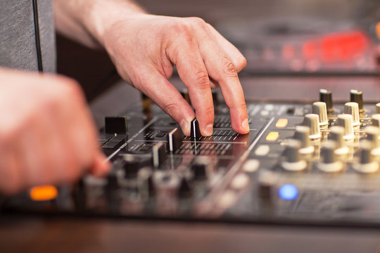 DJ mixing music on console