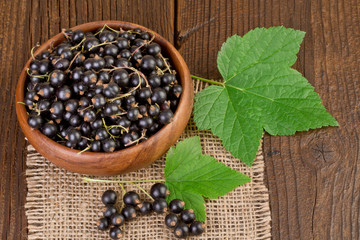 blackcurrant berries on rustic wooden background