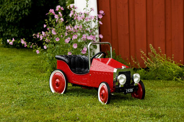 Red Toy Car Outside House