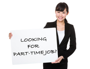 Confident businesswoman holding a board showing with looking for