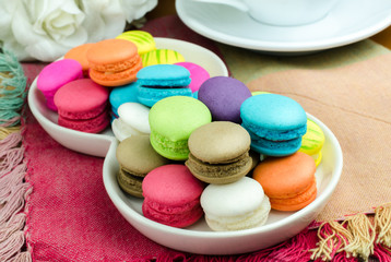 Colorful macarons on white plate/ Close up image