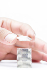 Money coins pile isolate on white background,hand putting on mon