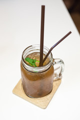 Ice tea in jar mug with lemon.