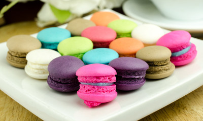 Fototapeta na wymiar Colorful macarons on white plate/ Close up image