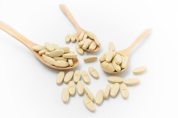 Vitamin on wooden spoon