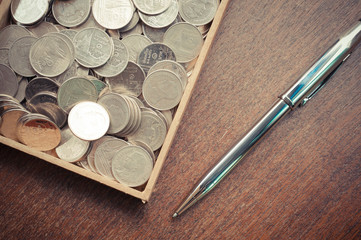 Pen and coins with filter effect retro vintage style