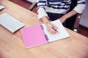 Casual woman writing notes