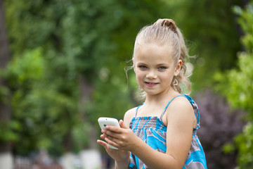 Portrait of brunette Caucasian schoolgirl with mobile phone