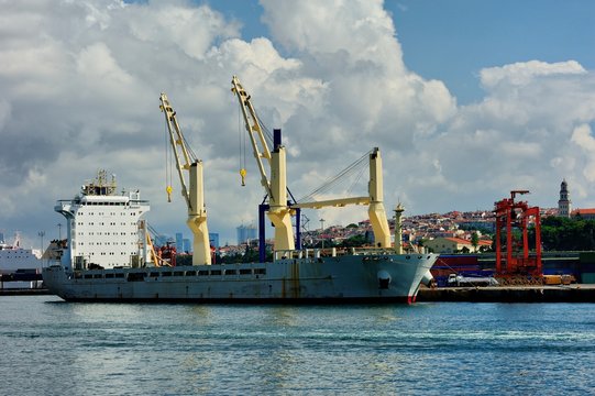 Cranes load containers on a large transport ship