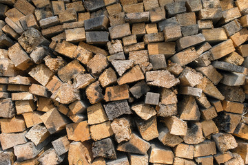 Many dry chopped firewood logs. Horizontal.