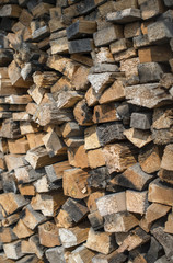 Many dry chopped firewood logs. Vertical.