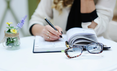 beautiful girl writing in a notebook