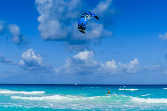 Male paraglider glides over the sea