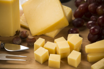 Different cheeses on a cutting board, delicious food