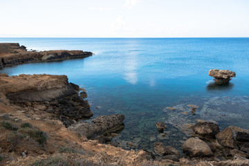 Fototapeta na wymiar Rocky sea cost and crystal clear waters of Cyprus