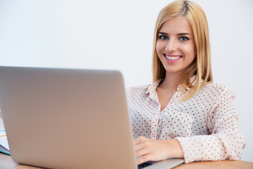 Fototapeta premium Happy young businesswoman using laptop