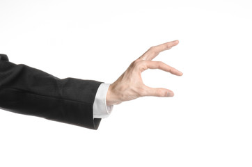 Businessman and gesture topic: a man in a black suit and white shirt showing hand gesture on an...