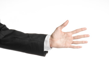 Businessman and gesture topic: a man in a black suit and white shirt showing hand gesture on an isolated white background in studio