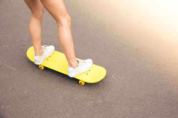 female legs on skateboard
