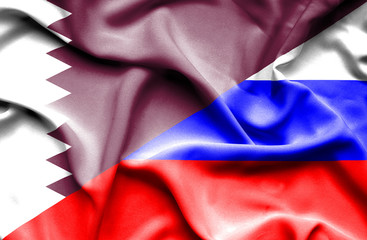 Waving flag of Russia and Qatar