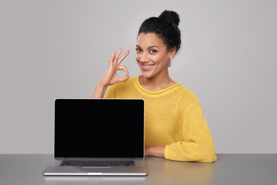 Happy woman showing blank black comuter screen