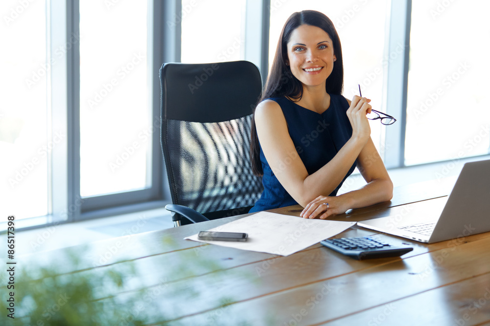 Wall mural business woman using her laptop computer at office. business people