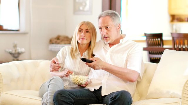 Mature couple watching TV