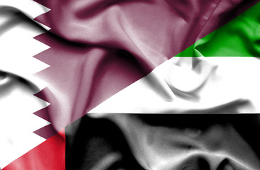 Waving flag of United Arab Emirates and Qatar